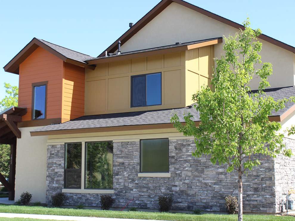 Large and beige traditional two floor house exterior in Boise with mixed cladding and a pitched roof.