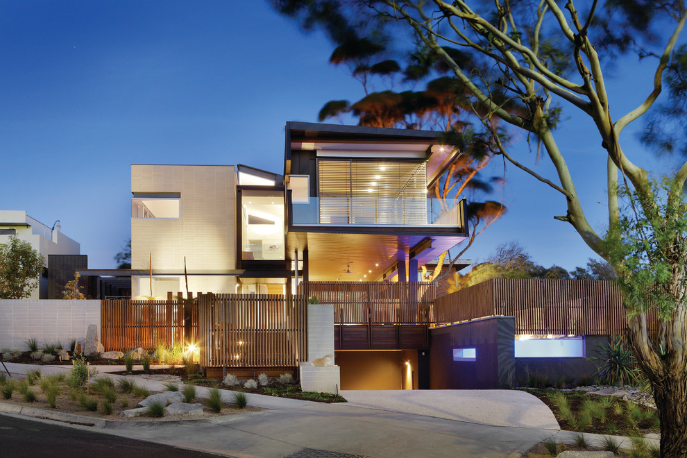 Beige contemporary house exterior in Melbourne with three floors and a flat roof.