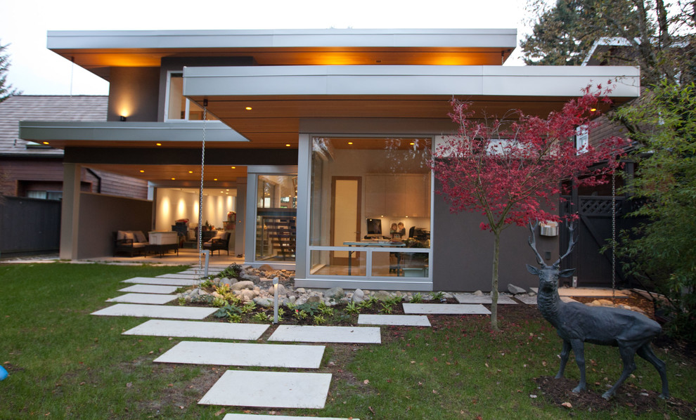 Mid-sized minimalist brown three-story mixed siding flat roof photo in Vancouver