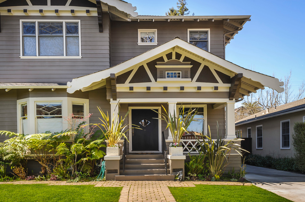 This is an example of a medium sized and brown traditional two floor house exterior in San Francisco with wood cladding, a pitched roof and a shingle roof.