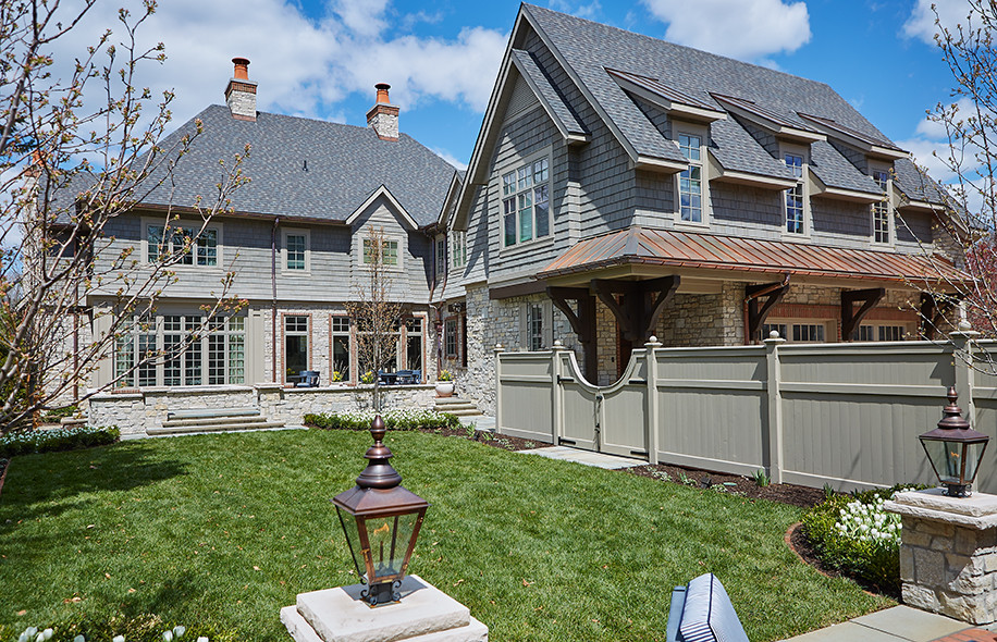 Photo of an expansive and gey classic house exterior in Grand Rapids with three floors and stone cladding.