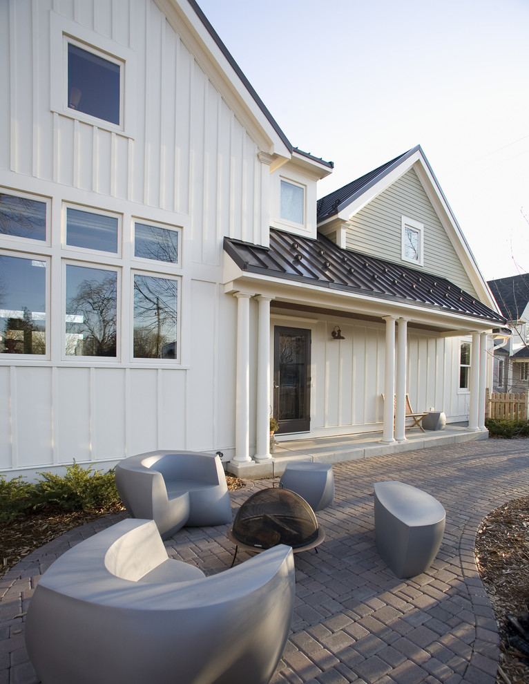 Example of a cottage white two-story wood exterior home design in Minneapolis with a metal roof