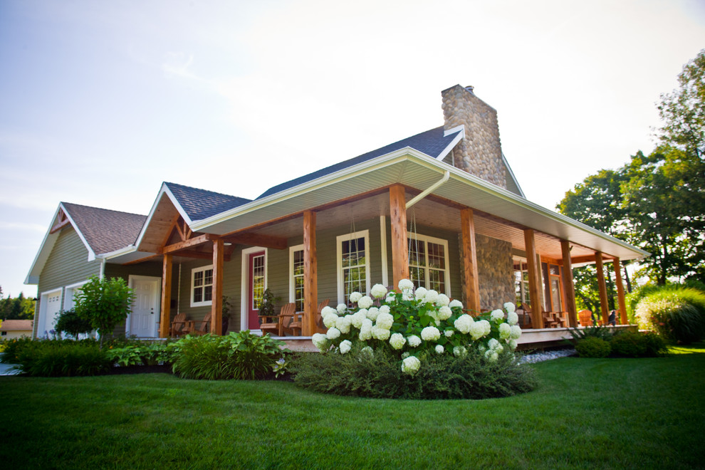 This is an example of a small and blue traditional bungalow house exterior in Toronto with wood cladding.