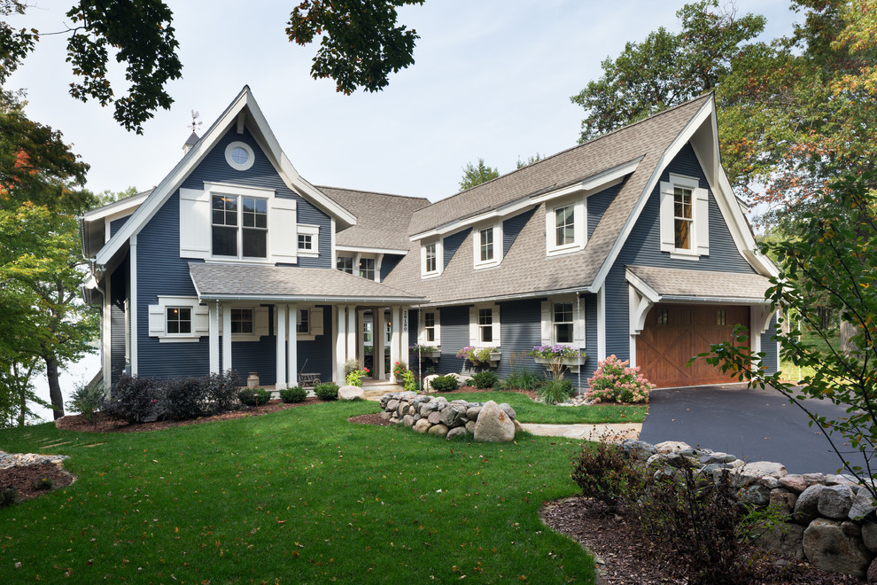 Large elegant blue three-story wood exterior home photo in Minneapolis with a shingle roof