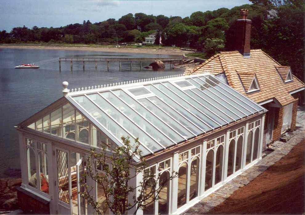 Inspiration for a large traditional bungalow glass house exterior in Boston with a pitched roof.