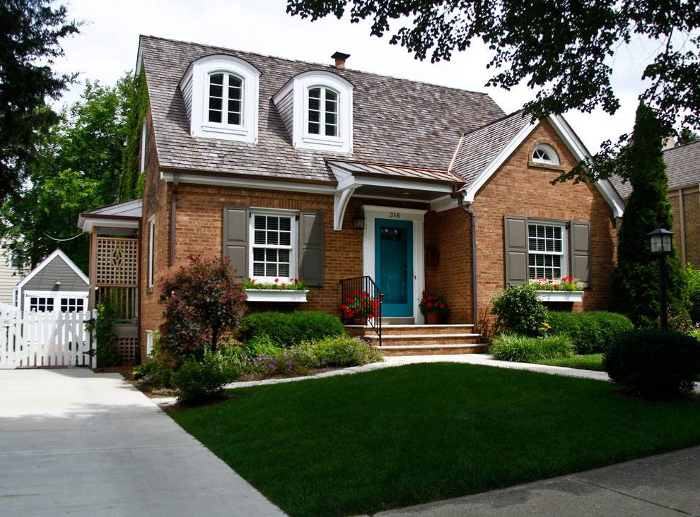 Example of a classic two-story brick exterior home design in Chicago
