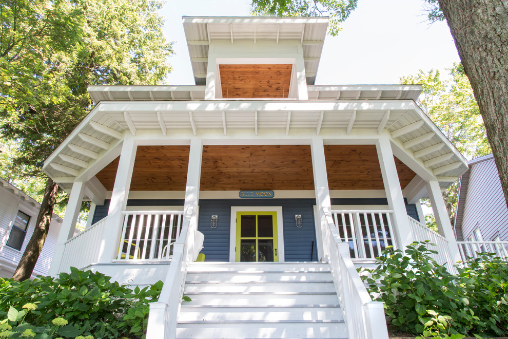 Inspiration for a mid-sized craftsman blue two-story vinyl house exterior remodel in Grand Rapids with a hip roof and a shingle roof