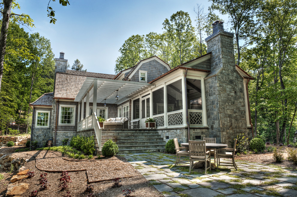 Mid-sized victorian gray two-story wood house exterior idea in Other with a gambrel roof and a shingle roof