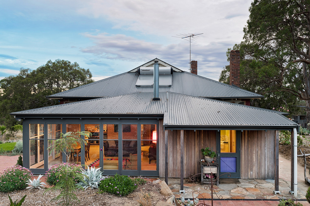 Inspiration for a farmhouse detached house in Adelaide with wood cladding and a metal roof.