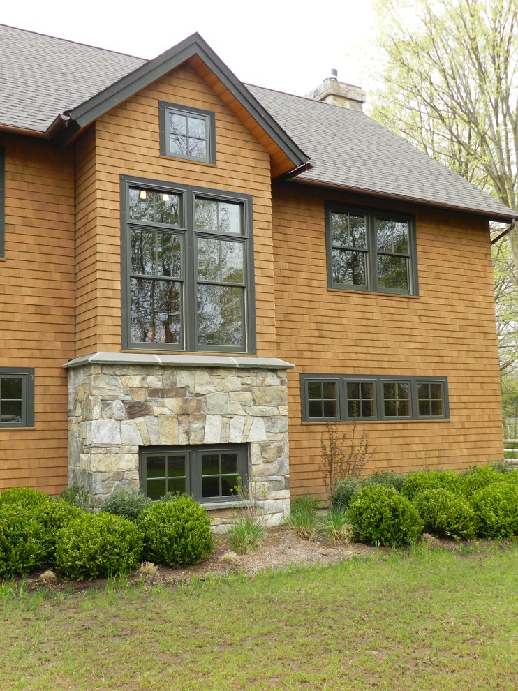 Example of an arts and crafts brown wood exterior home design in New York