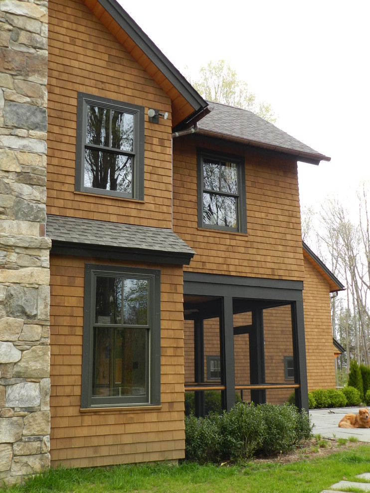 Photo of a brown traditional house exterior in New York with wood cladding.