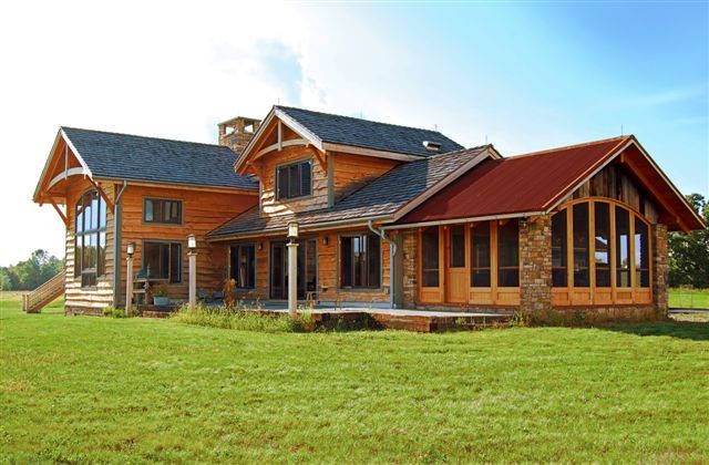 Design ideas for a rustic house exterior in New York with wood cladding.