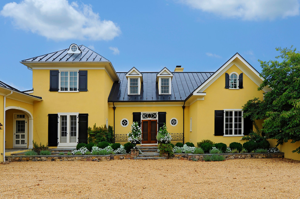 Immagine della facciata di una casa gialla classica a due piani