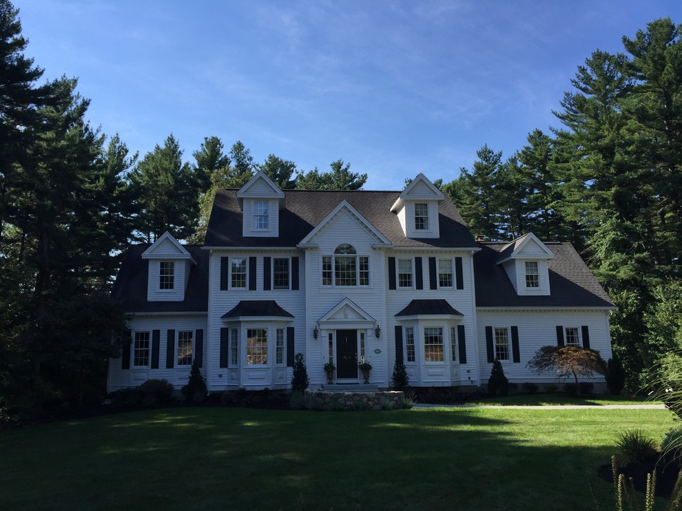 Inspiration for a mid-sized timeless white two-story vinyl gable roof remodel in Boston