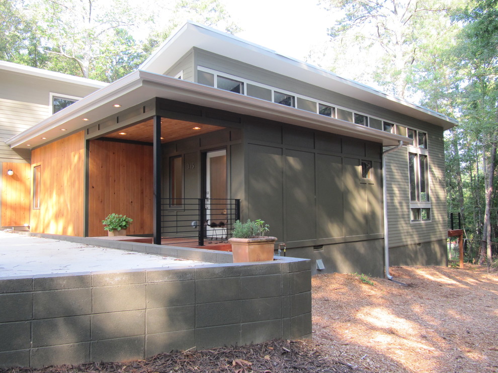 Inspiration for a modern two floor house exterior in Atlanta with wood cladding.