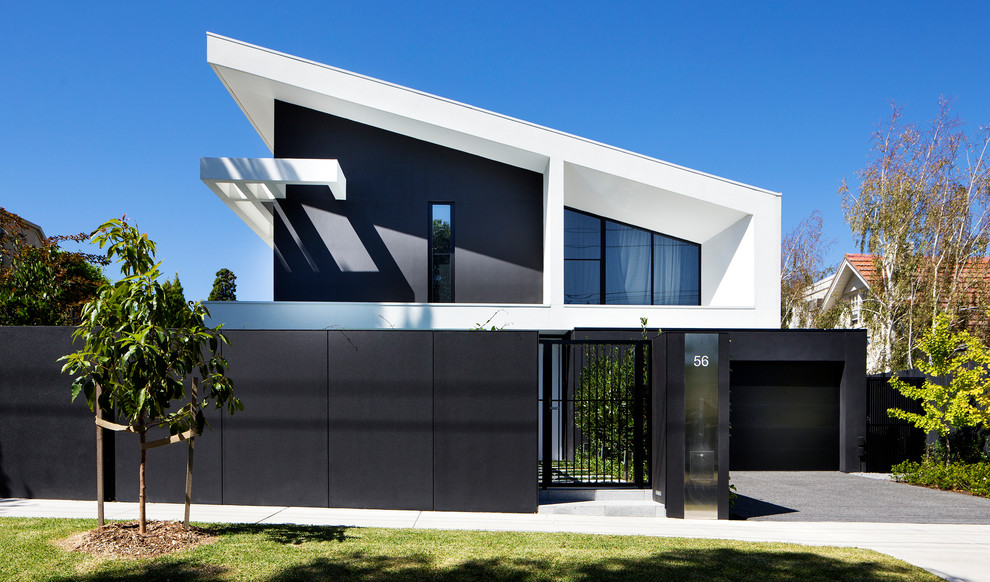 Idéer för ett modernt svart hus, med två våningar och pulpettak