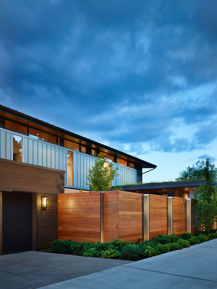 Example of a mid-century modern two-story exterior home design in Seattle