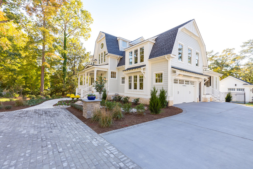 Example of a large trendy gray two-story wood house exterior design in Other with a gambrel roof and a shingle roof