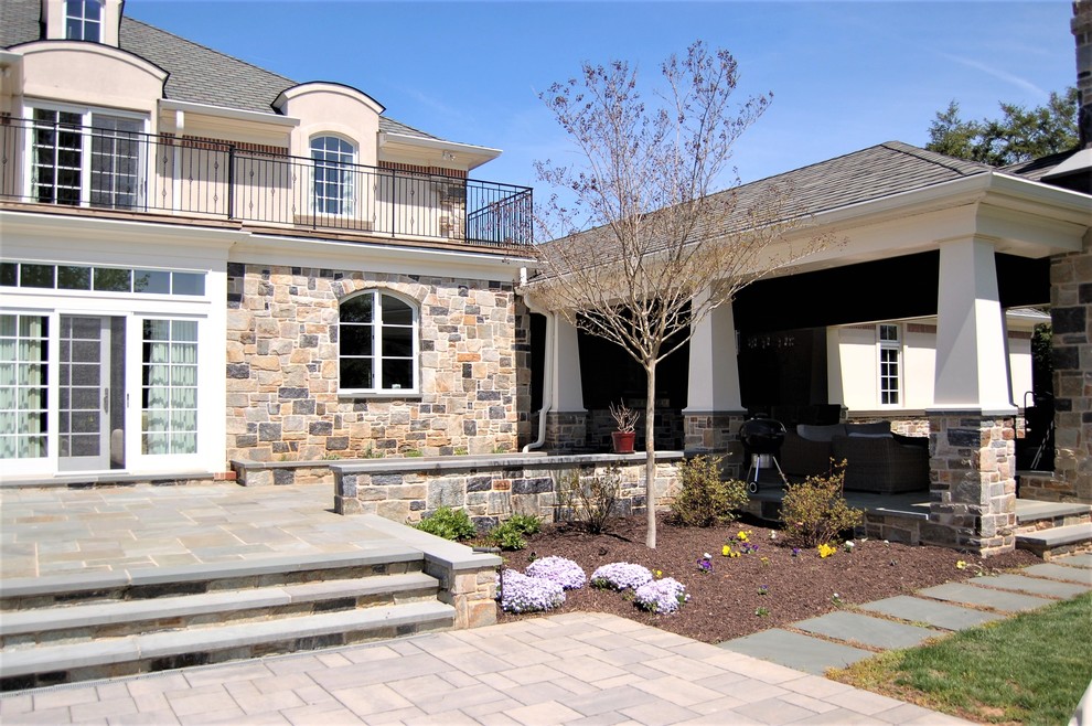 Photo of a large and multi-coloured classic two floor detached house in Baltimore with stone cladding, a hip roof and a shingle roof.