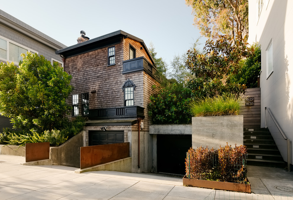 Photo of a medium sized classic house exterior in San Francisco with wood cladding and a pitched roof.