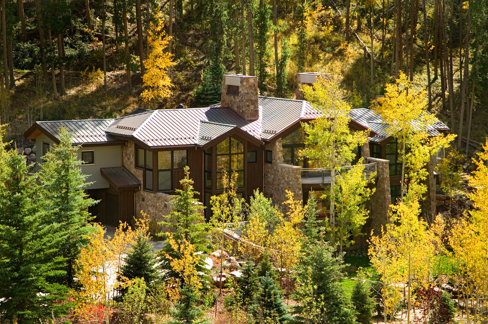 Design ideas for an expansive and brown rustic house exterior in Denver with three floors and mixed cladding.