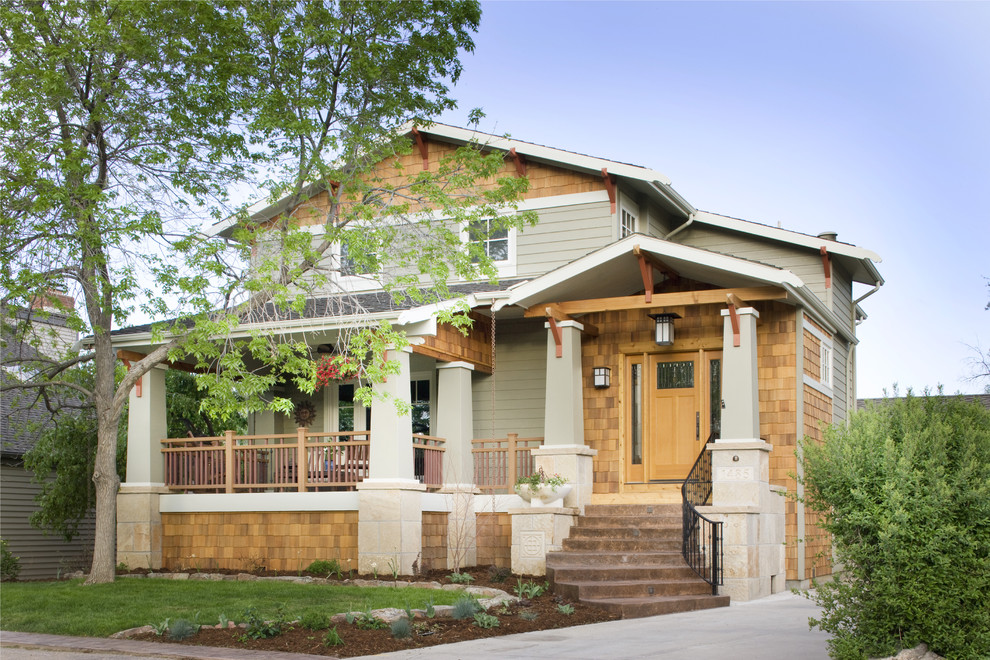 Example of an arts and crafts wood exterior home design in Denver