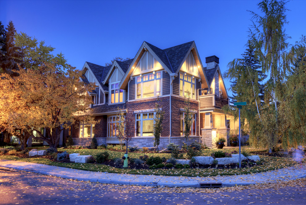 Large arts and crafts beige two-story brick exterior home photo in Calgary