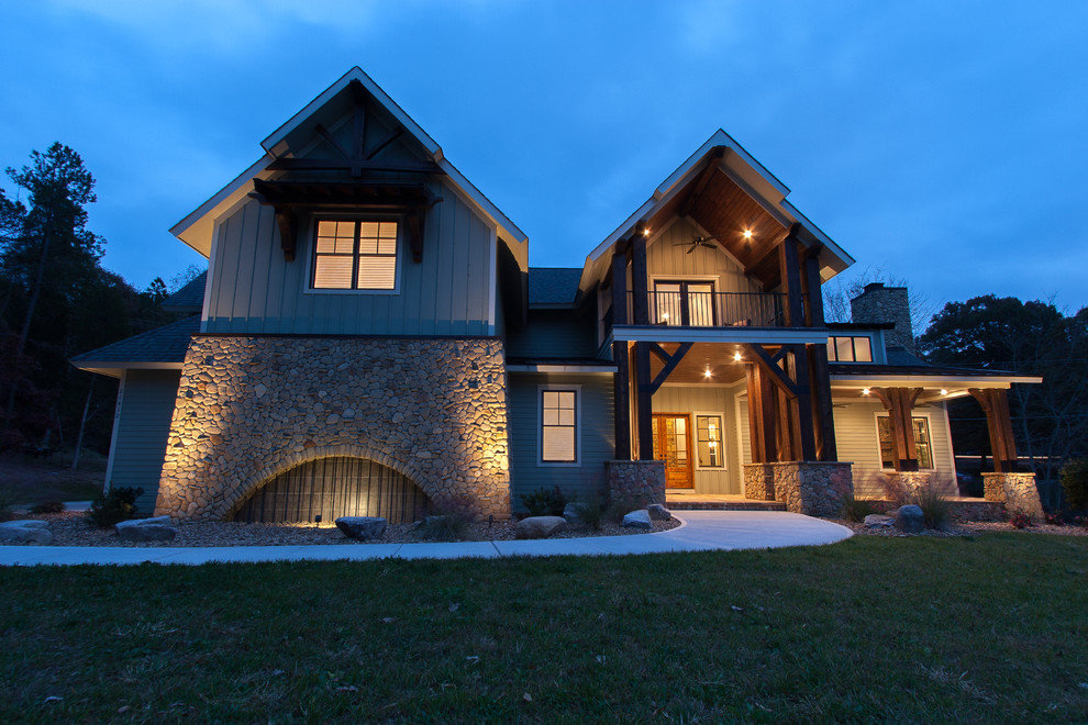 Large elegant gray two-story stone exterior home photo in Charlotte