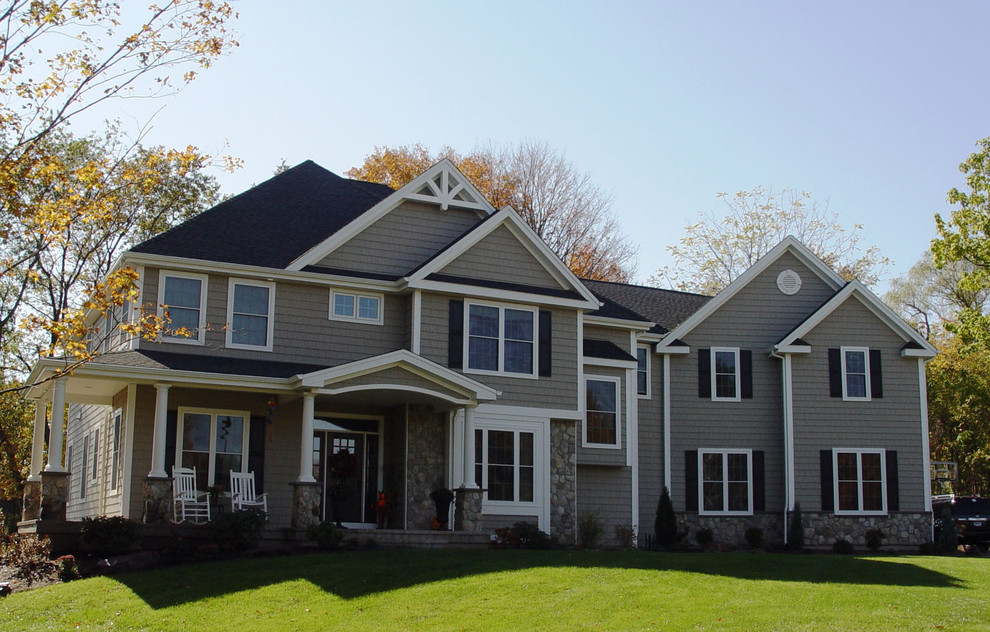 Example of a large arts and crafts gray two-story vinyl house exterior design in Bridgeport with a hip roof and a shingle roof
