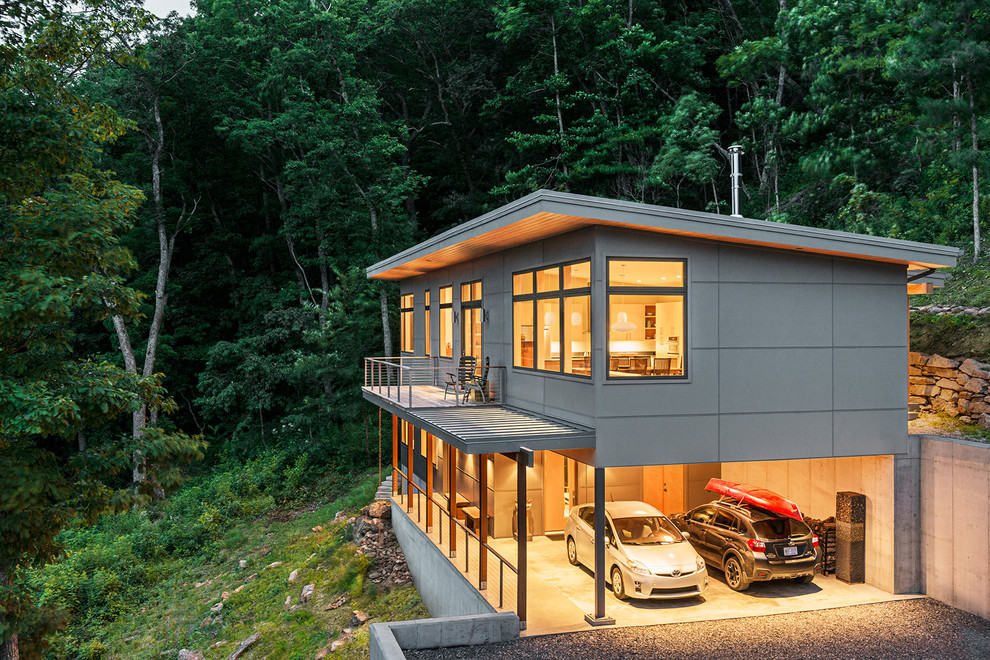 Kleines, Zweistöckiges Modernes Einfamilienhaus mit Betonfassade, grauer Fassadenfarbe und Pultdach in Sonstige