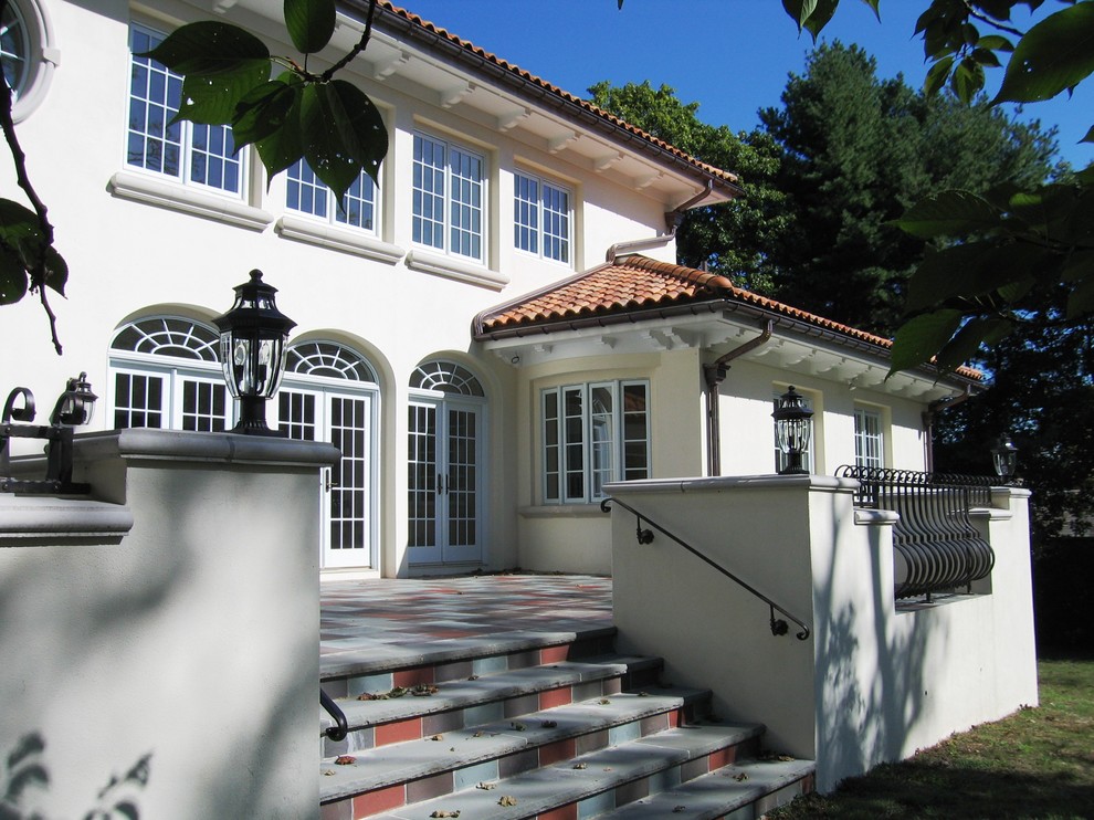 Example of a large tuscan white two-story stucco exterior home design in New York with a tile roof
