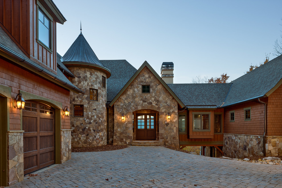 Rustic house exterior in Other with stone cladding.