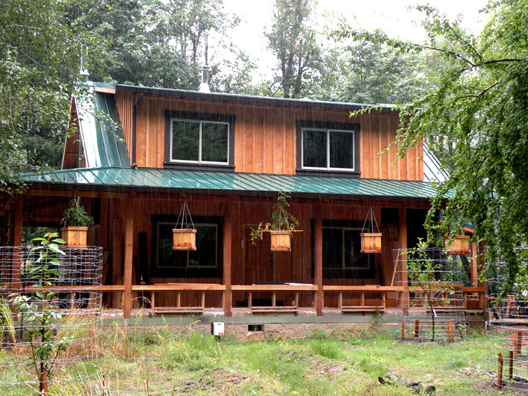 Inspiration for a small rustic two-story wood exterior home remodel in Portland