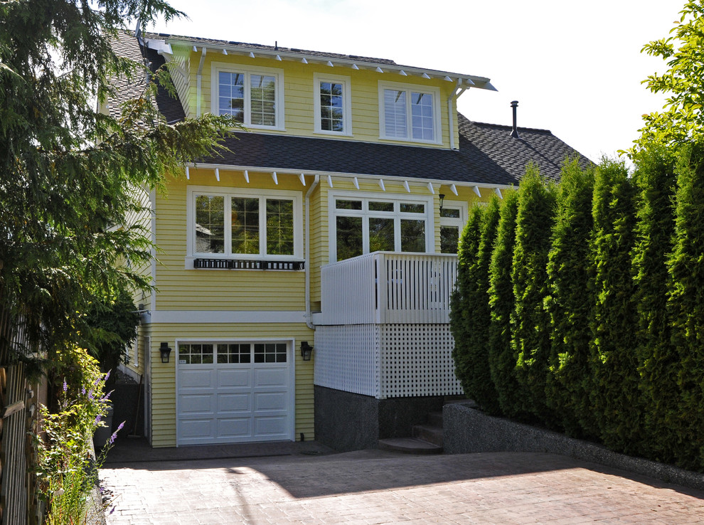 Example of a classic yellow wood exterior home design in Vancouver