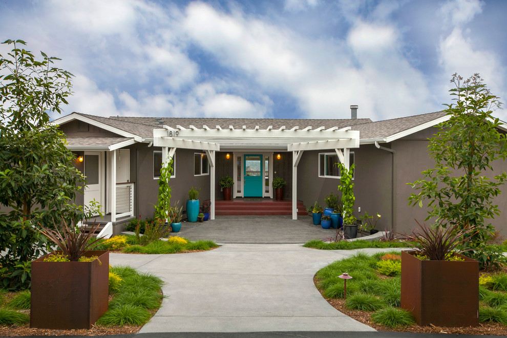 Photo of a medium sized and gey bohemian bungalow render house exterior in San Diego.