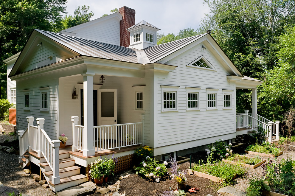 Photo of a rural two floor house exterior in New York with wood cladding.