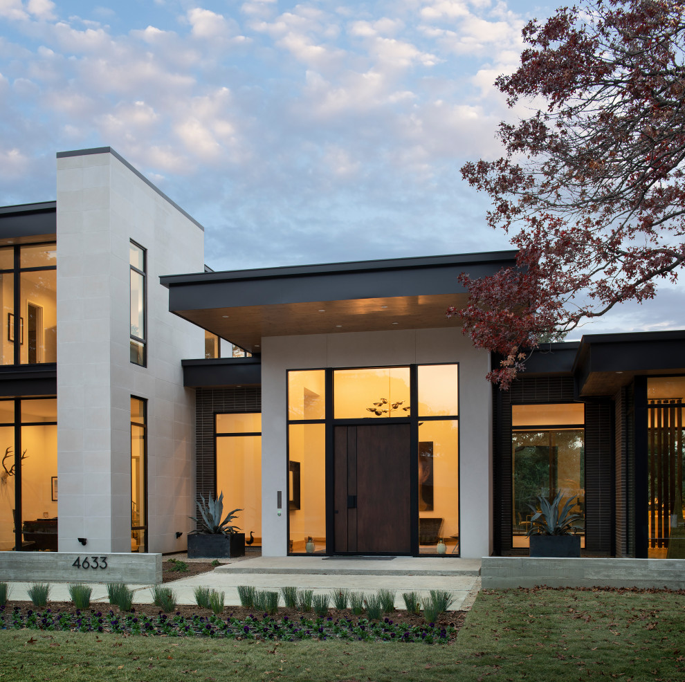 Modelo de fachada de casa multicolor moderna grande de dos plantas con revestimiento de ladrillo y tejado plano