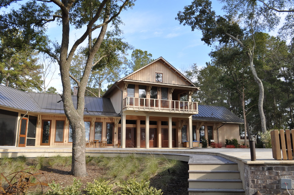 Inspiration for a large and beige rustic two floor house exterior in Atlanta with wood cladding and a pitched roof.