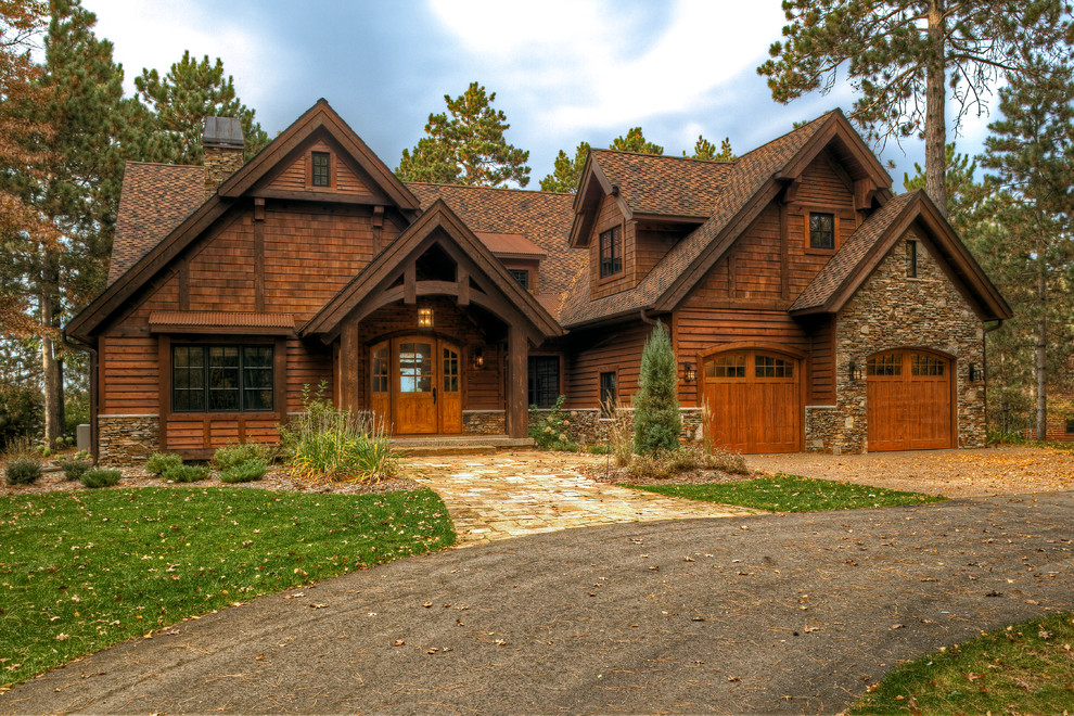 Photo of a large and brown rustic two floor house exterior in Minneapolis with wood cladding and a pitched roof.
