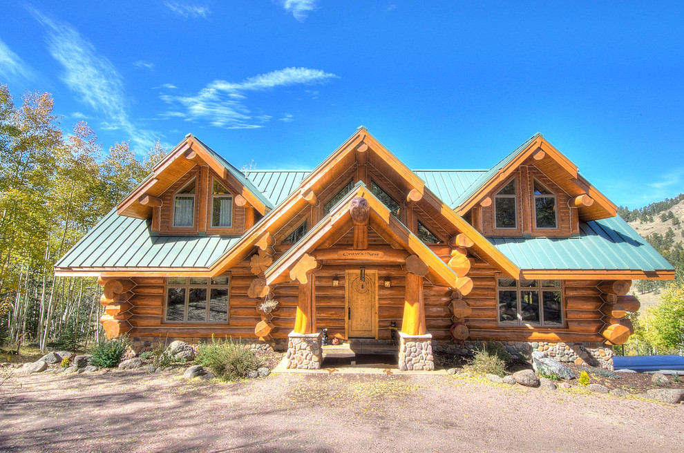 This is an example of a medium sized and brown rustic two floor detached house in Denver with wood cladding, a pitched roof and a metal roof.