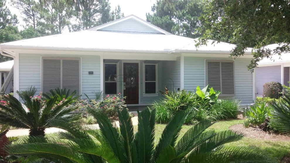 This is an example of a blue and small coastal bungalow detached house in Miami with vinyl cladding.