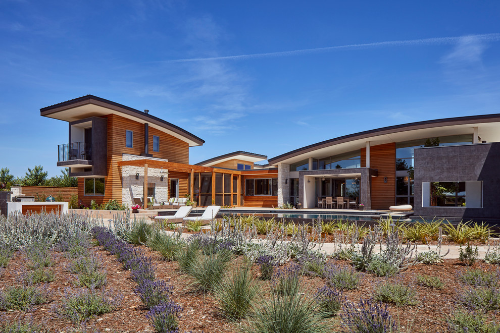 Large contemporary two-story mixed siding exterior home idea in Sacramento