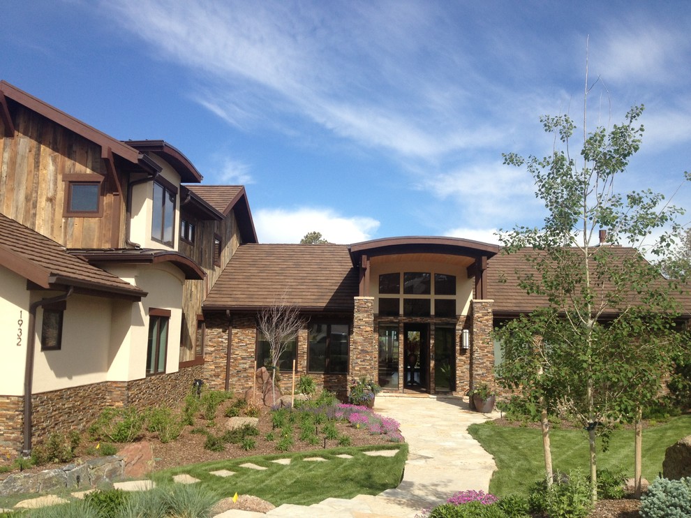Rustic house exterior in Denver with stone cladding.