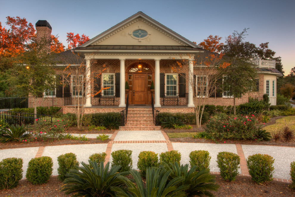 Elegant one-story brick exterior home photo in Charleston