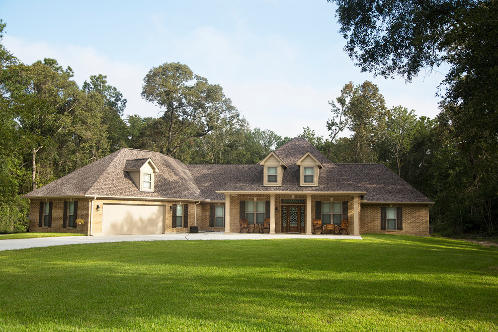 Large elegant beige two-story mixed siding house exterior photo in Atlanta with a hip roof and a shingle roof
