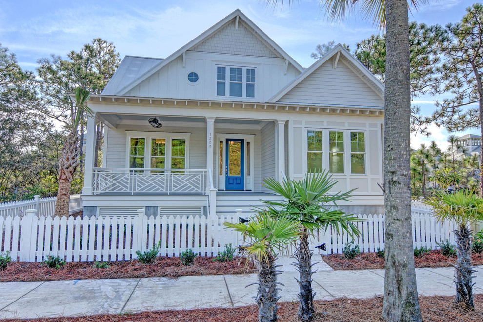 Example of a large beach style gray two-story mixed siding exterior home design in Other with a hip roof