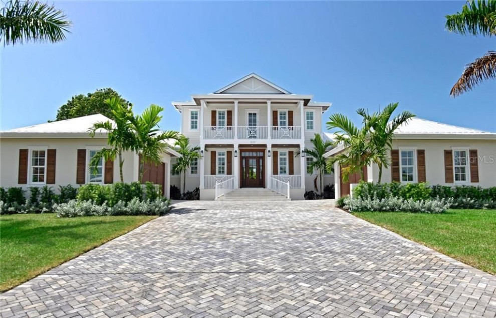 Inspiration for a large nautical detached house in Tampa with three floors and a metal roof.