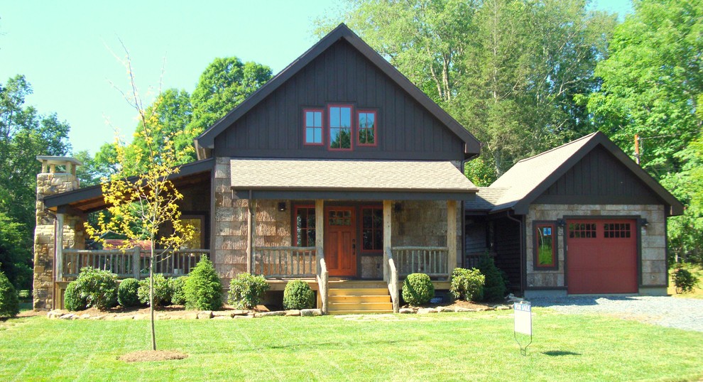 Inspiration for a rustic house exterior in Charlotte with wood cladding.