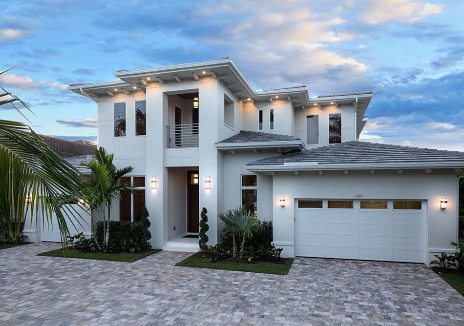 Example of a mid-sized trendy gray two-story stucco house exterior design in Other with a tile roof