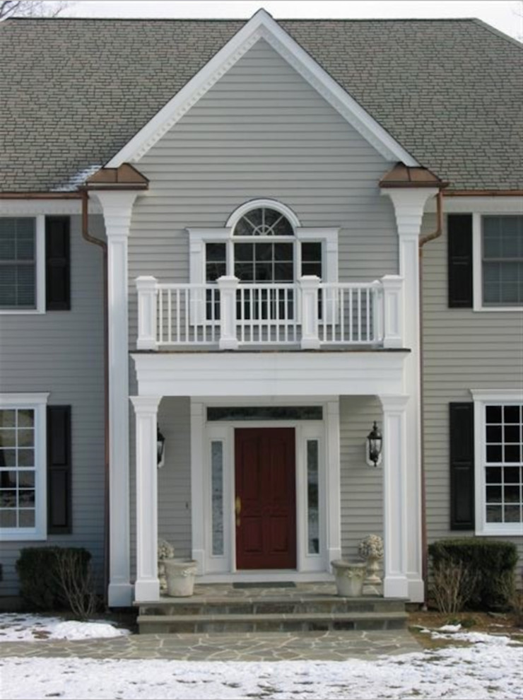 Example of a large classic gray two-story vinyl exterior home design in New York with a shingle roof
